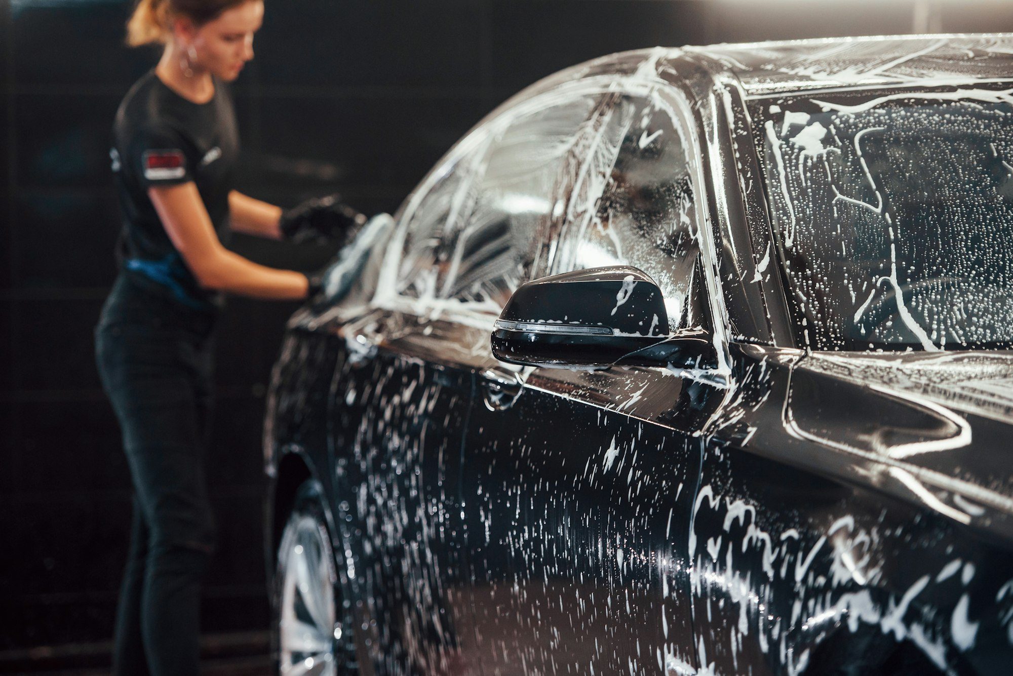 modern-black-automobile-get-cleaned-by-woman-inside-of-car-wash-station-2-e1719217996667.jpg
